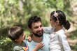 © Antonio Recena - Father with son and daughter playing in pine forest