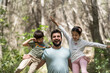 © Antonio Recena - Father with son and daughter playing in pine forest