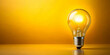 © janya - Light bulb shining brightly on a vibrant yellow background, innovation, creativity, idea, inspiration