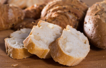 Wall Mural - Slices of wheaten bread on wooden surface