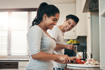 Canvas Print - Couple, cooking and laugh with talking in kitchen for funny memory, joke and helping hand for meal prep. Woman, man and smile with chat, bonding or connection with love, vegetables or food for diet