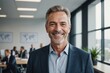 © ThomasLENNE - happy middle aged older professional business man, smiling mature executive ceo manager, mature male entrepreneur, rich confident business owner standing in office looking at camera, portrait