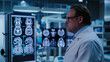© Ali - a doctor looking at computer screen showing MRI scan with brain images in a medical clinic