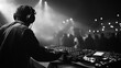 © Ashgan - rear view of a dj mixing at great festival party , with crowd of people in background
