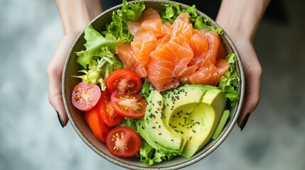 Wall Mural - Healthy Young woman holding Salted salmon salad bowl with fresh green lettuce,smoked salmon,tomato,Ketogenic,diet lunch bowl,enjoy eat clean vegetables after exercise,Healthy food concept.