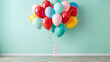 © Arief - colorful balloons of various sizes floating against a soft pastel-colored wall background