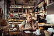 © Davor - Waitress looking stressed while calculating bill at restaurant table