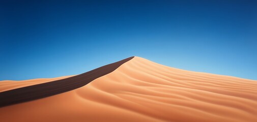 A stunning desert landscape featuring a tall sand dune under a clear blue sky, showcasing the beauty of nature's formations.