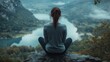 © ifoto - Woman sitting on a rock overlooking a lake and valley