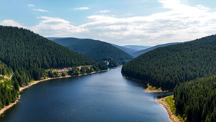 Wall Mural - Aerial drone footage of a Oasa Lake from Sureanu mountains, Alba county, Transalpina, Transylvania, Romania. Romanian wild nature and landscape from above. 4K drone footage