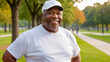 © QuoDesign - Plus size senior black man wearing white t-shirt and white baseball cap standing in the park