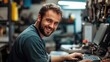 © Thanos - Smiling Mechanic Working on Laptop in Auto Repair Shop with Modern Car Parts Store in Background
