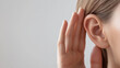 © Taskmanager - A close-up of a person’s hand cupping their ear, indicating active listening, attention, and communication skills, often associated with dialogue, understanding, and empathy.
