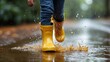 © Artem - Child running in yellow rain boots through puddles