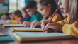 © alan - Kids writing and helping in class for education concept