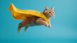 © Andres Mejia - Ginger cat wearing superhero cape flying through air