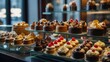 © Artem - Small cakes on display at patisserie counter