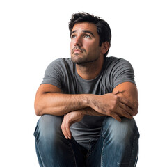 Wall Mural - A man sitting alone with his arms wrapped around his knees, looking off to the side with a distant, empty expression isolated on transparency background