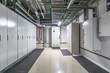 © alhim - A clean and organized electrical room features multiple control panels and wiring, highlighting the industrial design and functionality of the space..