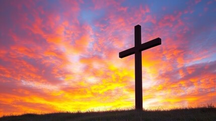 A cross silhouetted against a sunset sky.