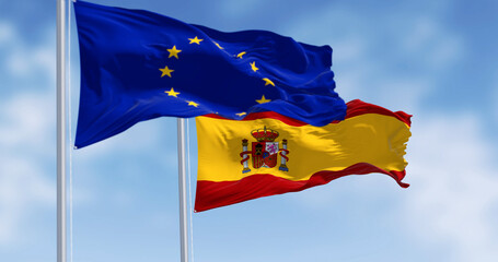 Wall Mural - National flag of Spain waving with the European Union flag on a clear day