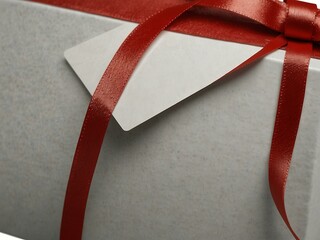 Wall Mural - Gift card wrapped in red ribbon, blank for any occasion.