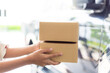 © banjongseal324 - Parcel box and human hand,Customer signing document and receiving the parcel from delivery man,Delivery woman delivering box to the man