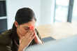 © SensSai/peopleimages.com - Woman, employee and head pain in office, injury and computer glitch for photophobia migraine. Female person, headache and professional in workplace for 404 error, red glow and inflammation strain