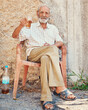© SensSai/peopleimages.com - Portrait, senior man and drinking beer in retirement on front porch, ancient architecture or wall. Pensioner, male person and comfort in old age with alcohol beverage, relax and elderly care in Italy