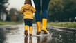 © Piere - Photo of a mother and child wearing yellow rain boots jumping in puddles on an overcast day