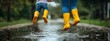 © Piere - Photo of a mother and child wearing yellow rain boots jumping in puddles on an overcast day