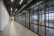 © alhim - Spacious office corridor decorated in loft style. Glass partitions divide the office .space.