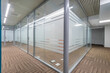 © alhim - Modern design of the working floor in a large corporate office. Glass cubicles. Original .floor covering.