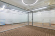 © alhim - A study in a large corporate office. Glass doors and partitions. Brown floor covering.