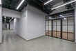 © alhim - A working floor with a long corridor in a corporate office. White brick walls. Glass .cubicles.