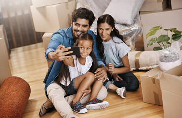 Happy family, picture or box with selfie for new home, memory or moving in together on floor. Father, mother and young daughter, child or kid with smile for photography, moment or property investment