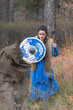 Viking warrior girl in blue in autumn