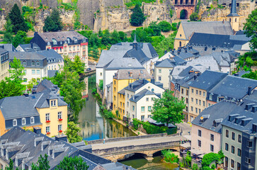 Luxembourg City historical centre aerial view with old colorful buildings on narrow streets, Pont du Grund bridge across Alzette river, top view of Luxembourg old town Grund district