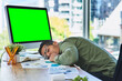 © SensSai/peopleimages.com - Man, computer and green screen with sleeping in office with burnout, paperwork and graphs with mockup space. Person, tired and exhausted by pc with blank ux, chromakey or documents with charts at job