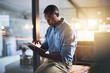 © peopleimages.com - Dark, tablet and black man in office for business, connectivity and research for webdesign. Programmer, schedule and reading on tech for software information, company website update or online review