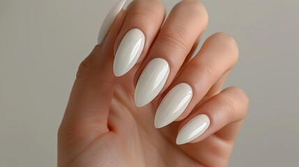 Close up front view of a woman s manicured hand with white nails on a light gray background