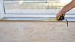 © Yurginn - Measurement of the lenth of the window  sill.