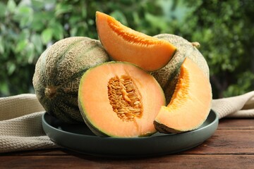 Fresh ripe Cantaloupe melons on wooden table, closeup