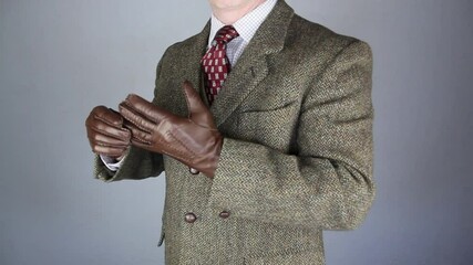 Wall Mural - Gentleman in Tweed Suit Teasing Off Leather Gloves in Flamboyant Manner. Eccentric English Gentleman.