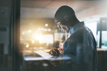 Leinwandbilder - African, businessman and tablet screen for research at night as corporate communication specialist. Male person, working late and tech for connection, internet and company as professional in office