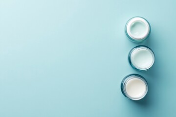 Wall Mural - Face cream in jars on light blue background, flat lay. Space for text .generative ai