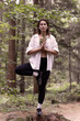 © Sabineyro - young woman in the forest standing the tree yoga pose