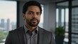 © Alteisen Riese - adult black hair hispanic man in gray formal attire model portrait looking confident on an office background for ad concept space for text