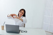 © dmitriisimakov - Business brunette woman showing her hands heart laptop online