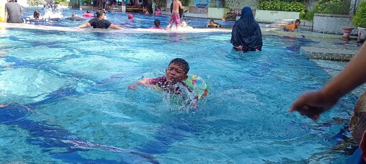 children swimming in the pool